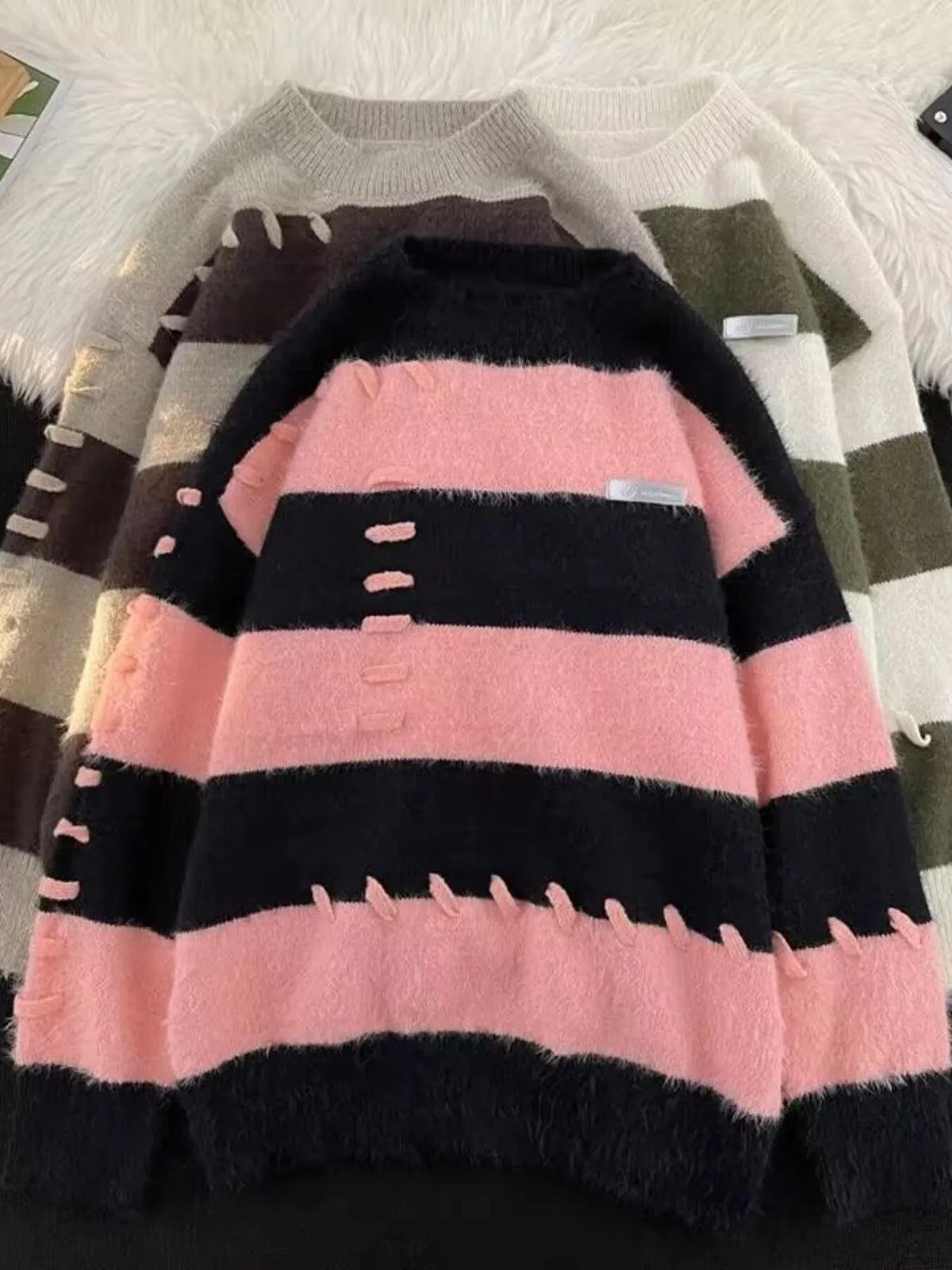 Men's striped knit round neck pullover sweater by Trendsi, featuring a classic design with colorful horizontal stripes.