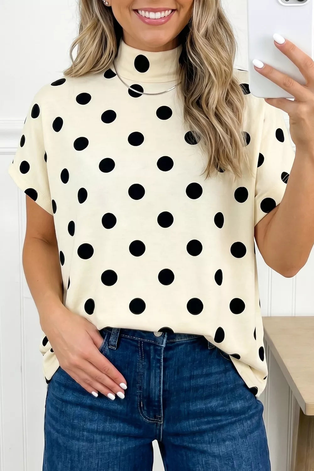 Polka dot print high neck dolman top from Trendsi, featuring a relaxed fit and stylish design for casual or chic outfits.