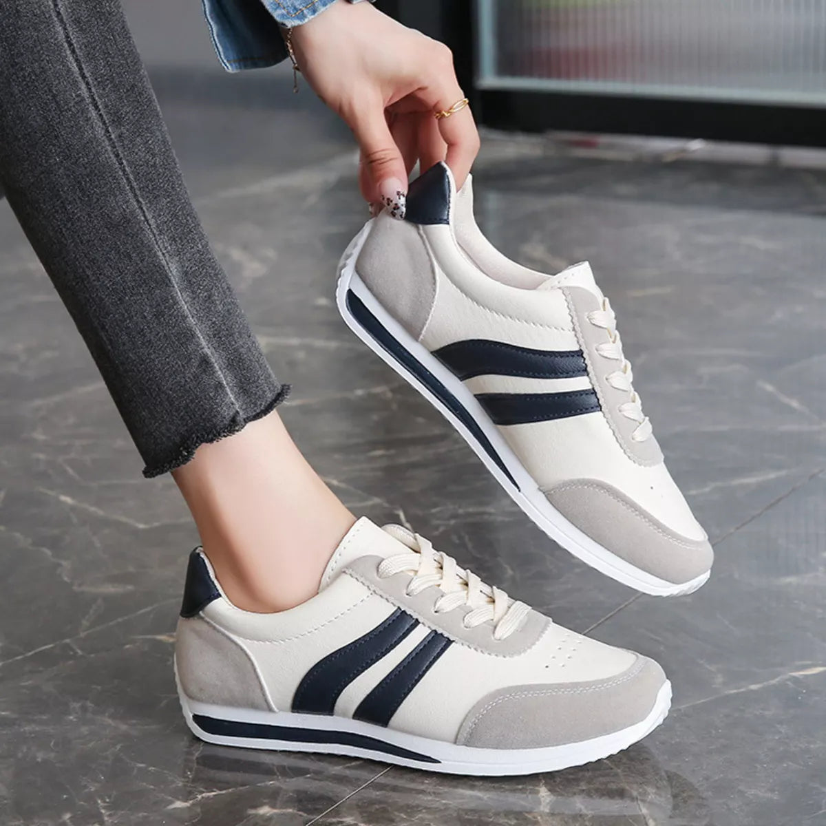 Women’s round toe lace-up sneakers from Trendsi featuring a classic design with white fabric and rubber sole.