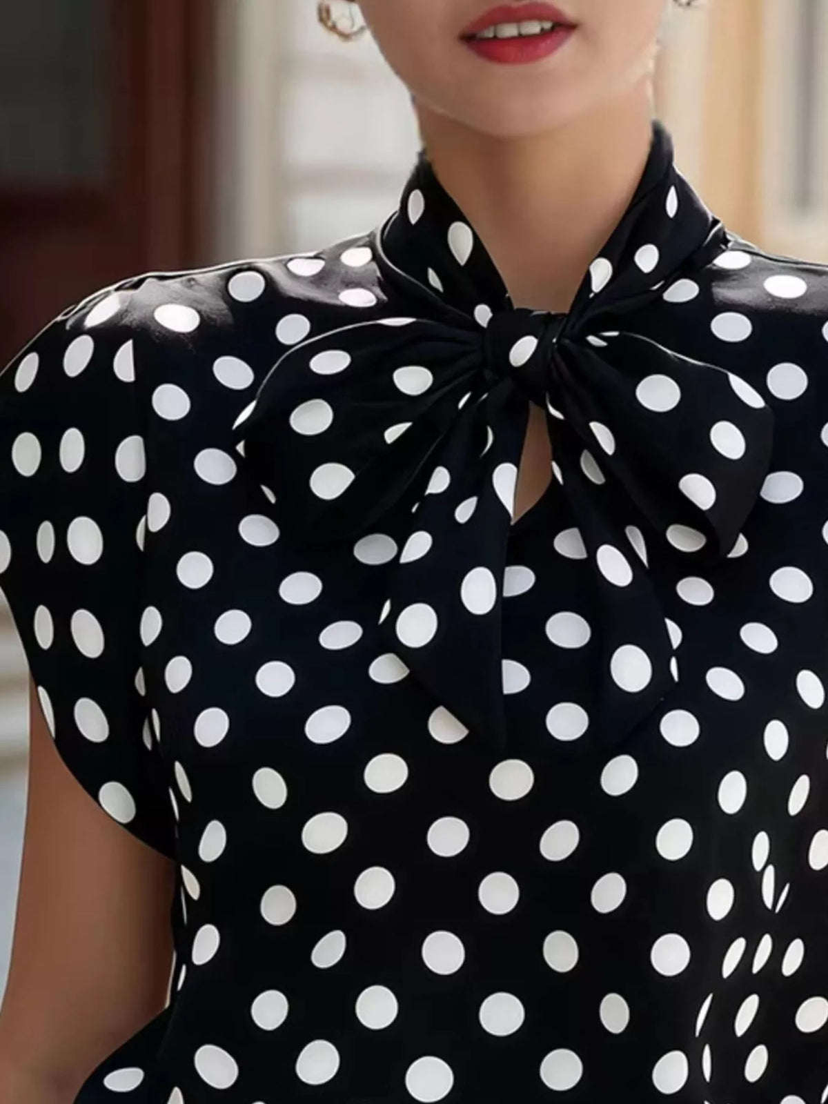 Polka dot tie neck blouse from Plush Fashion Hub, stylish tops with a feminine design and button closure.