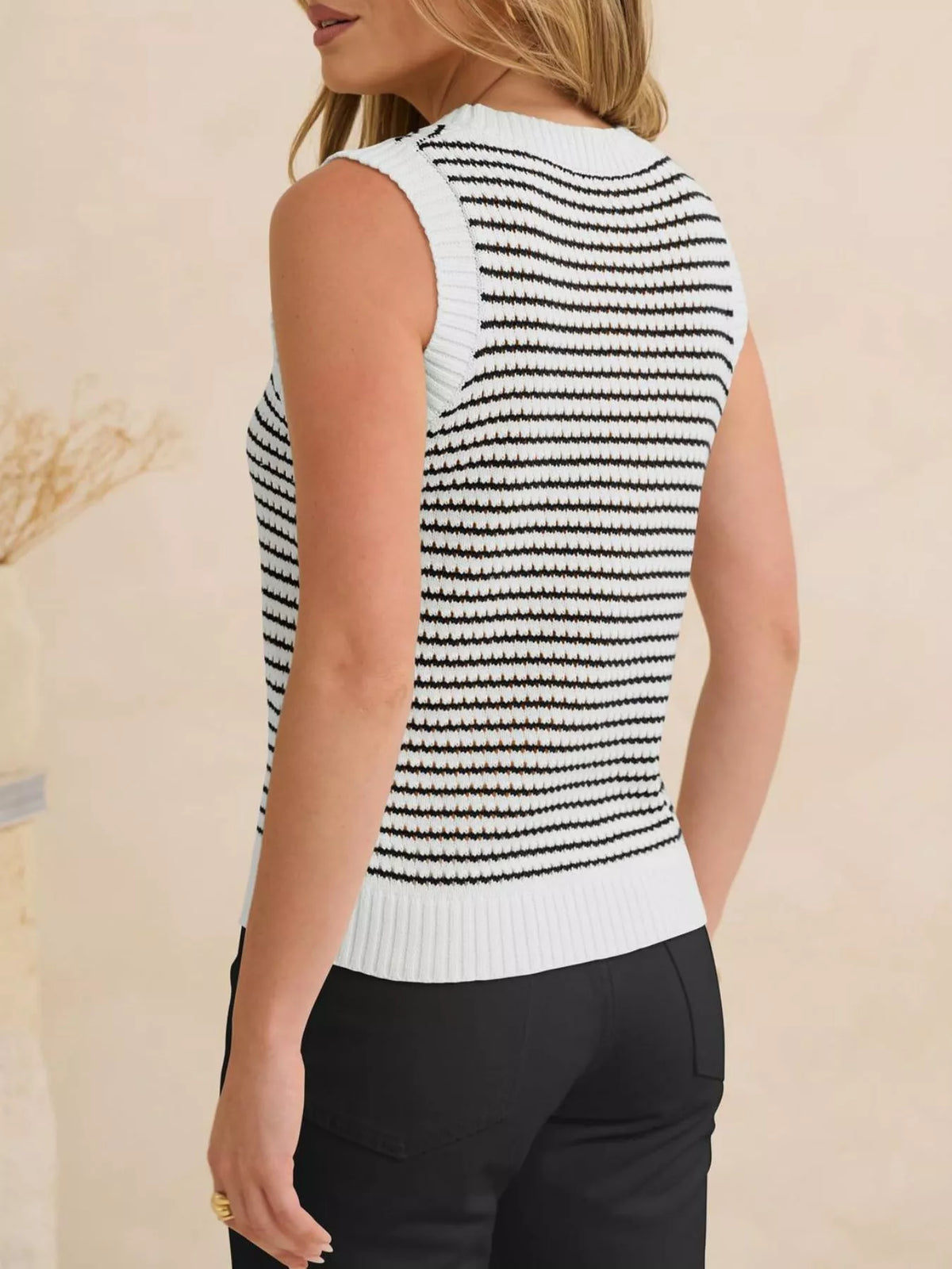 Striped knit sweater vest from Plush Fashion Hub, featuring a cozy design with colorful horizontal stripes and a ribbed neckline.