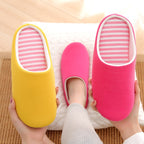 Soft cotton indoor slippers: yellow and vibrant pink slip-ons with white trim and pink-and-white striped insoles.