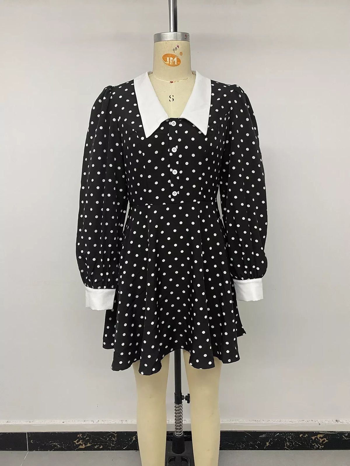 Polka dot Peter Pan collar dress by Plush Fashion Hub featuring a classic design and a charming collar detail.