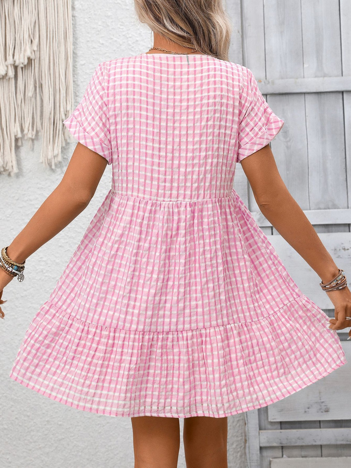 Plush Fashion Hub plaid V-neck mini dress with ruffle hem, featuring a chic design and stylish fit, shown on a model.
