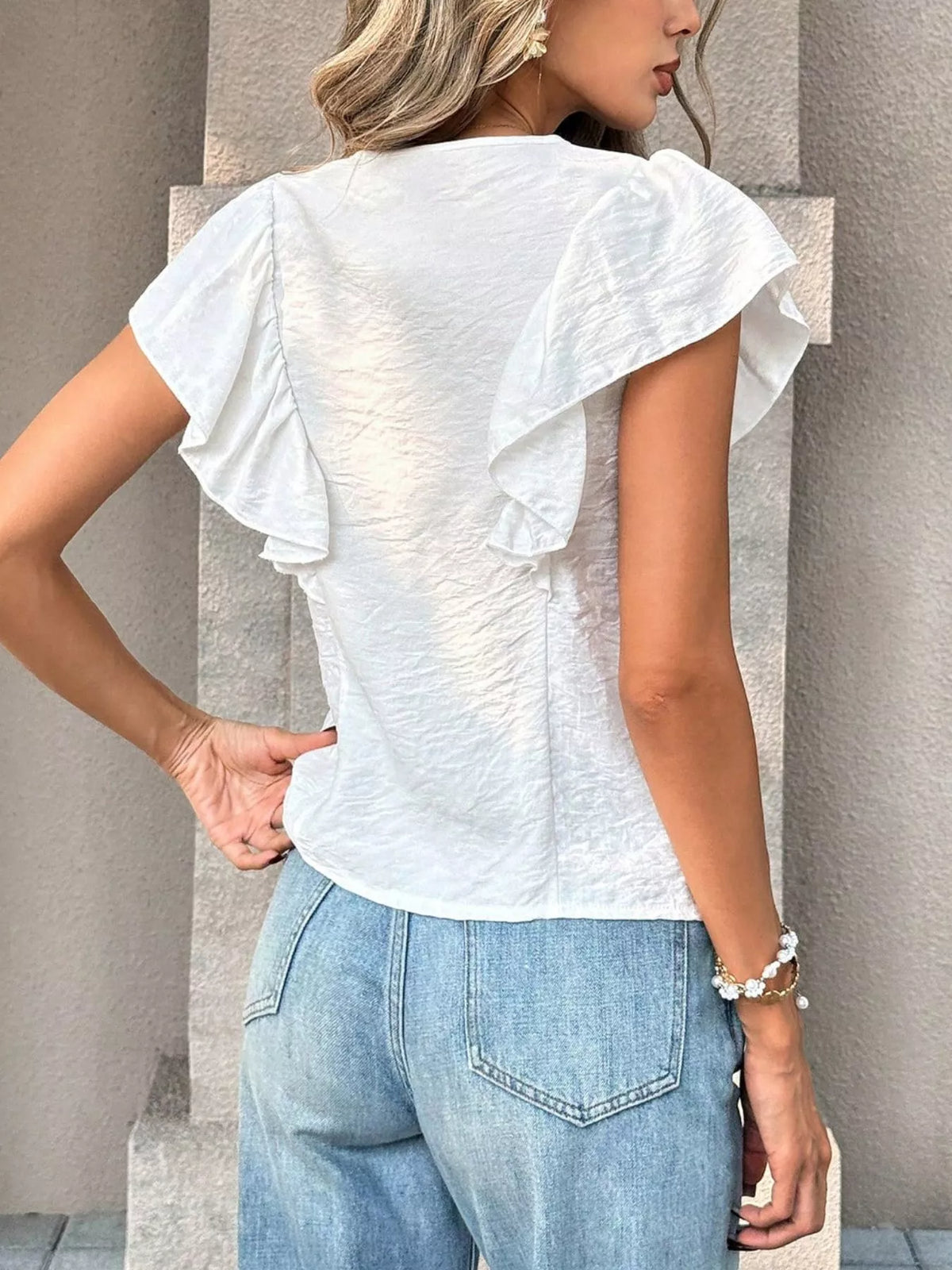 Plush Fashion Hub ruffled V-neck blouse in soft fabric, featuring a stylish ruffle detail at the neckline and a relaxed fit.