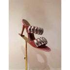 Clear buckle open-toe stilettos heels by eprolo featuring transparent straps and a sleek, high-heeled design.