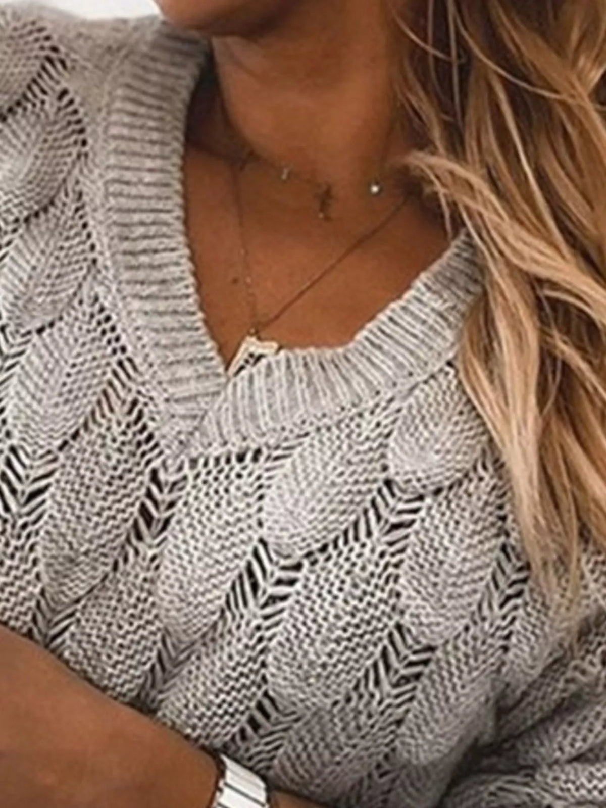 V-neck knitted sweater by Trendsi, showcasing a cozy, stylish sweater with a V-shaped neckline and textured knit pattern.