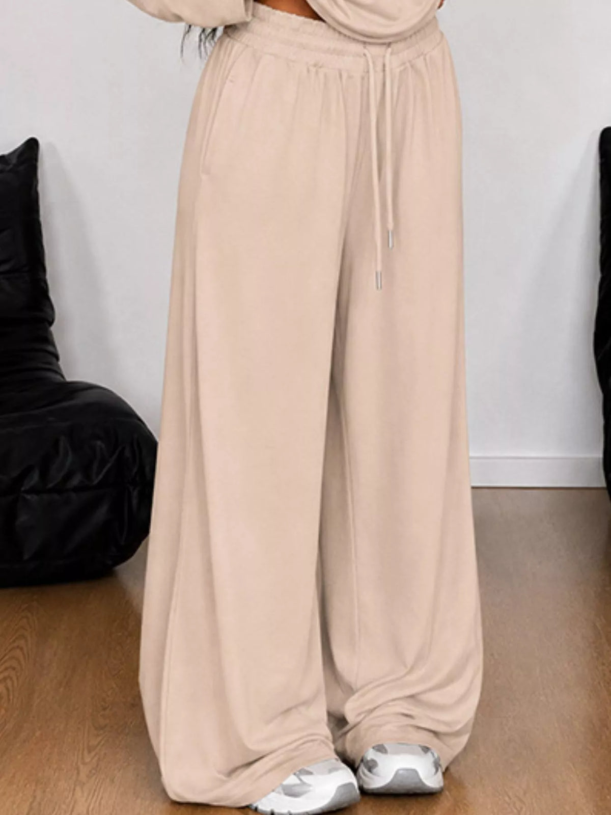 Plus size one-shoulder top and drawstring pants set from Trendsi, featuring a stylish matching set in a full size.