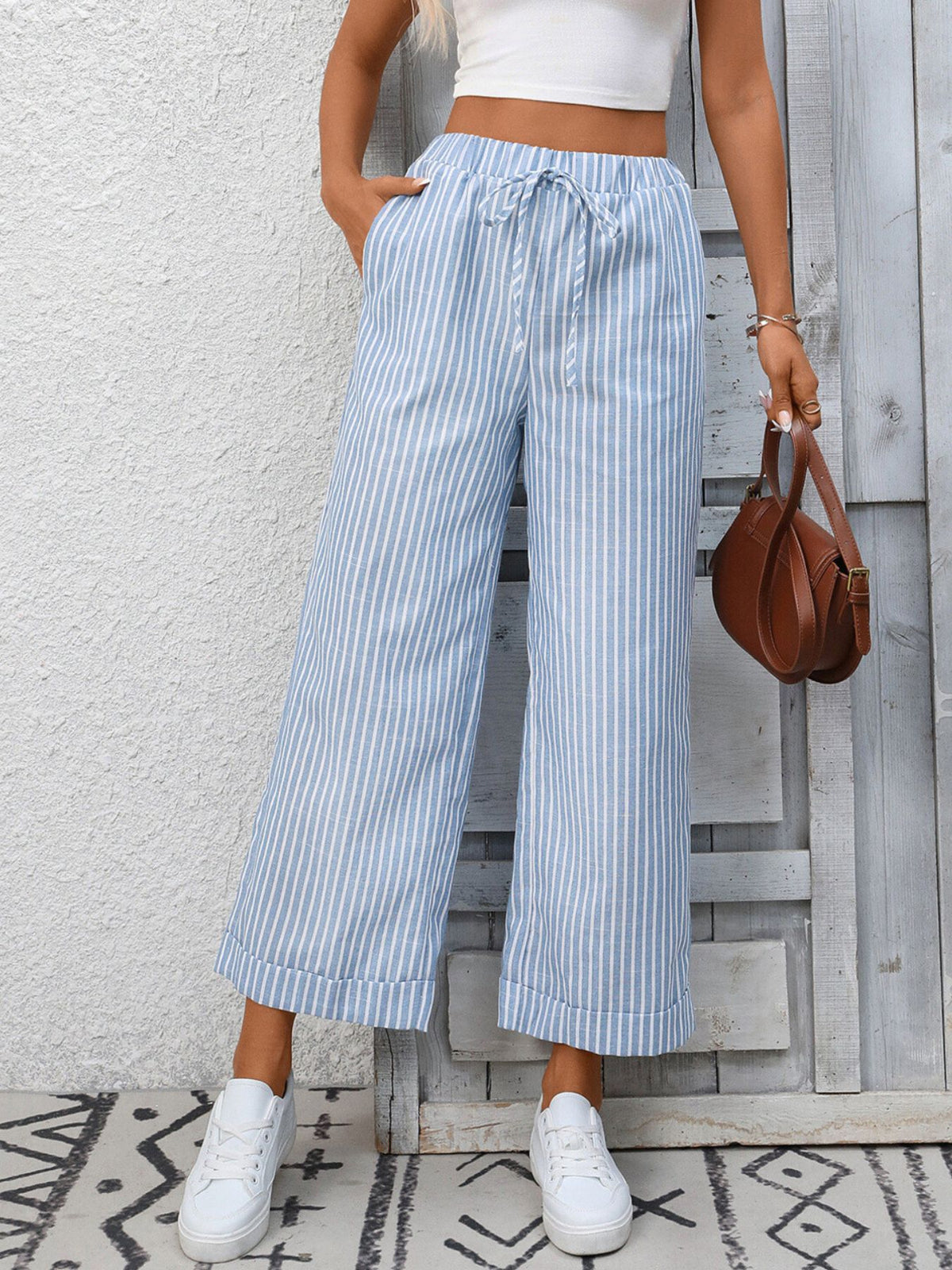 Women’s striped wide-leg drawstring pants with pockets by Plush Fashion Hub, featuring a relaxed fit and comfortable waistband.