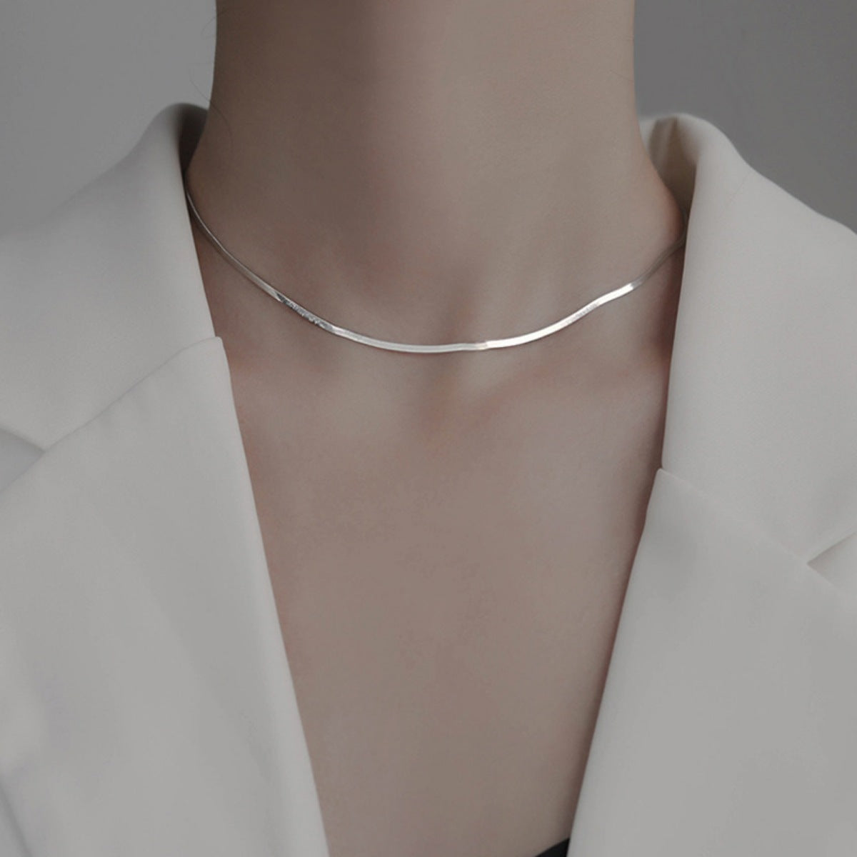 Sterling silver chain necklace from Plush Fashion Hub featuring a delicate, polished silver design on a white background.