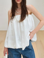 Women's strapless bubble hem tube top by Trendsi, sleek minimalist crop top with a fitted silhouette and trendy design.