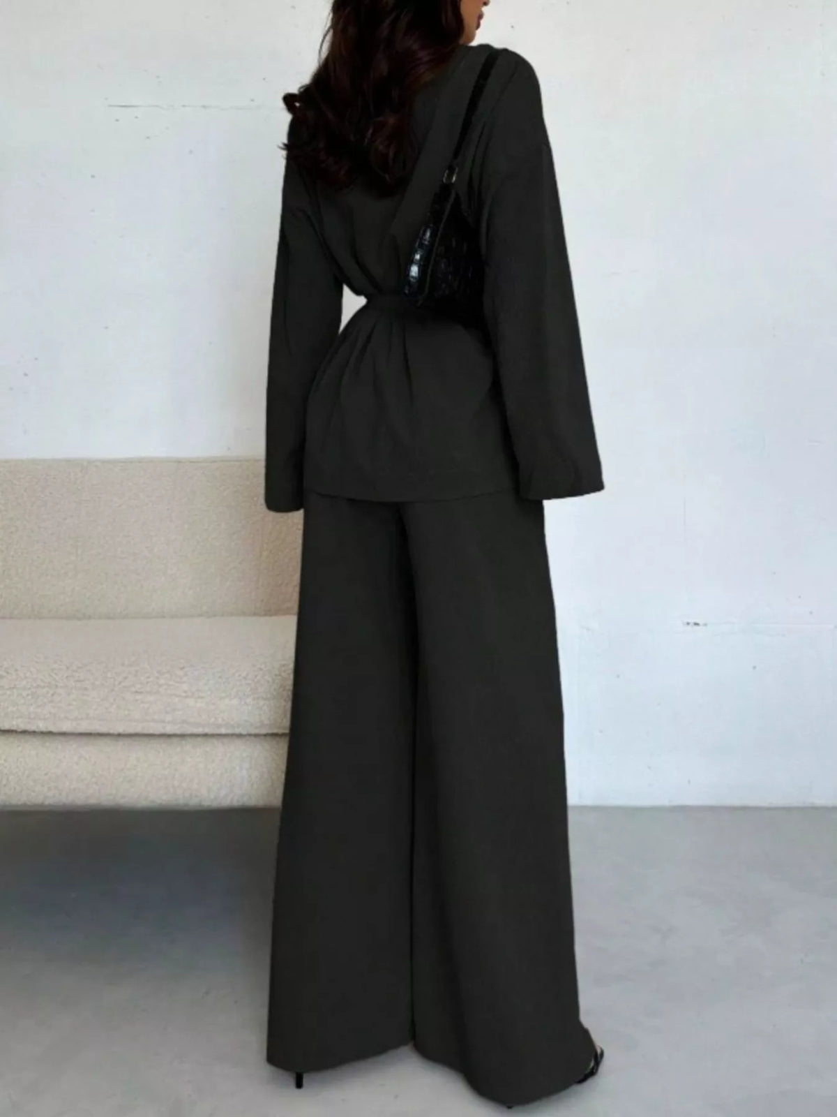 Textured tie waist top and wide-leg pants set for women, featuring a stylish, coordinated fashion look by Trendsi.