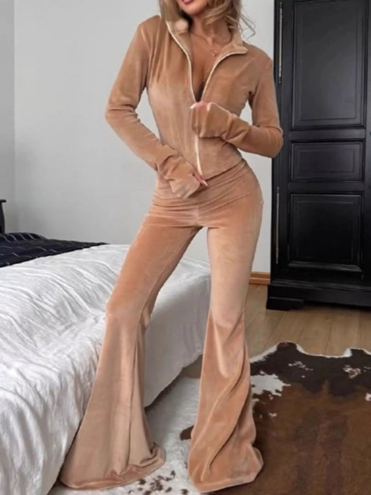 Trendsi zip-up crop top and flared pants two-piece set, stylish and fitted for casual or trendy outfits.