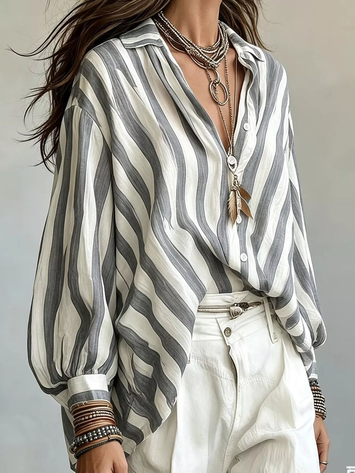 Women’s loose fit striped shirt by Trendsi, featuring a casual relaxed style with horizontal stripe pattern and soft fabric.