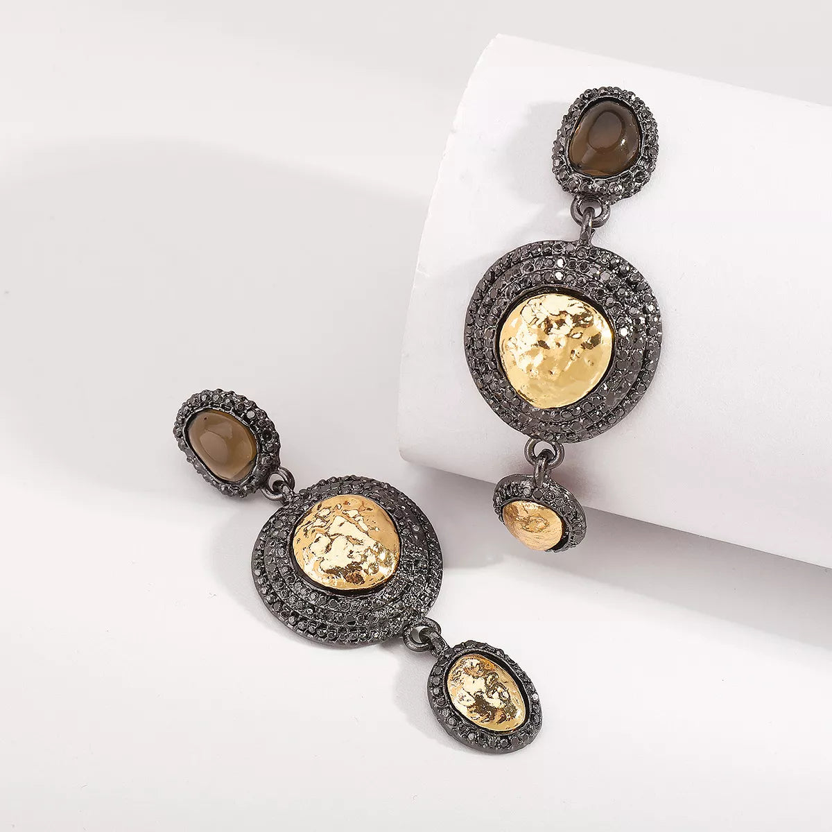 Vintage-inspired gold accent dangle earrings with intricate details, perfect for a stylish and elegant accessory.
