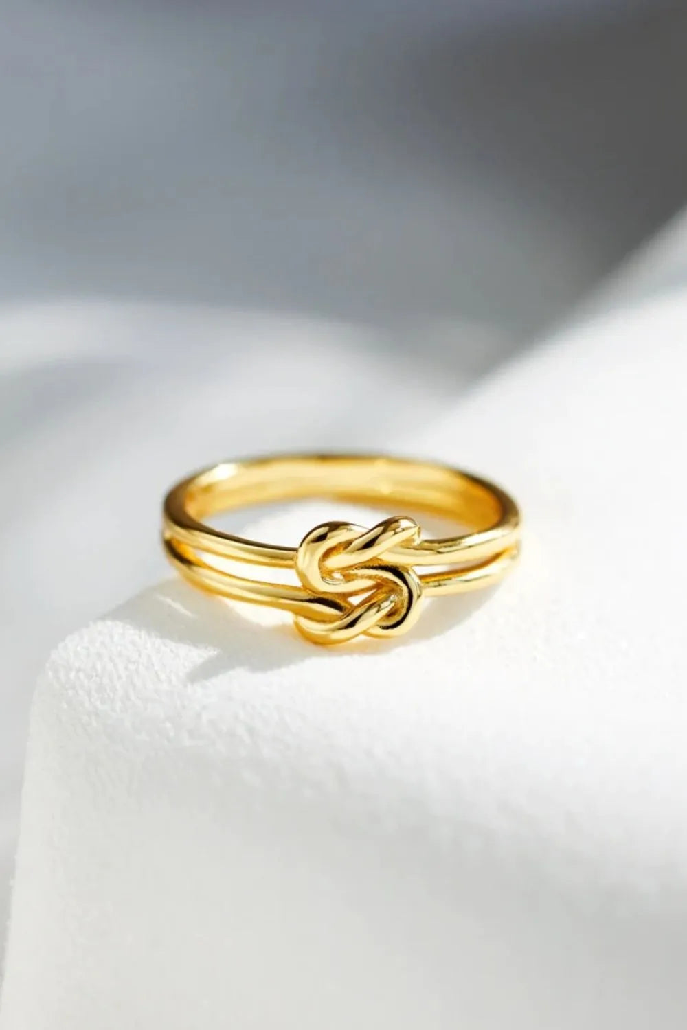 Sterling silver knotted ring from Plush Fashion Hub featuring a sleek, elegant design with a polished finish.