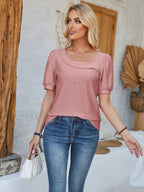Black eyelet asymmetrical neck short sleeve T-shirt from Trendsi, featuring a stylish design with a unique neckline and casual fit.