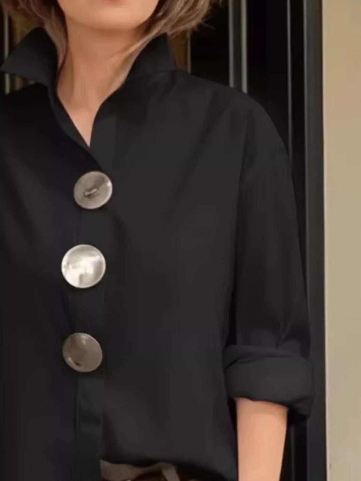 Plus size oversized metal button long sleeve shirt by Trendsi, featuring a relaxed fit and metal button details.