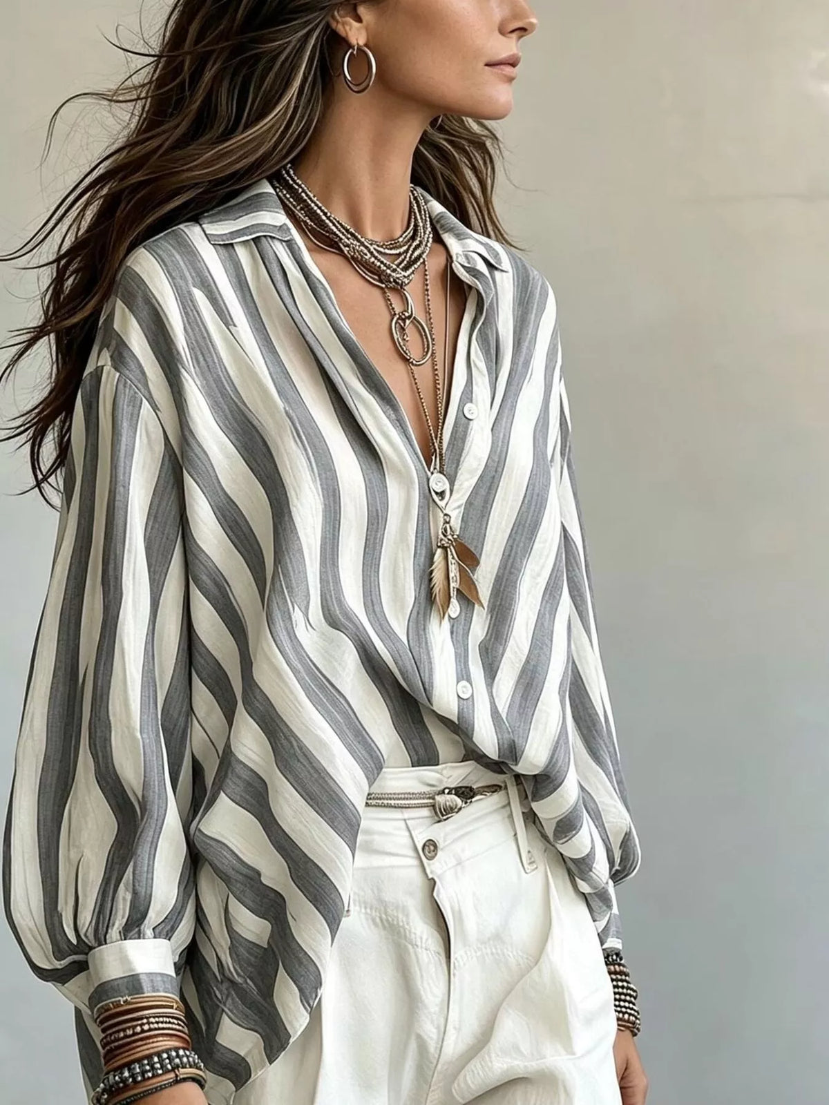 Women’s striped loose fit shirt by Trendsi, featuring a relaxed style with horizontal black and white stripes, lightweight and casual.