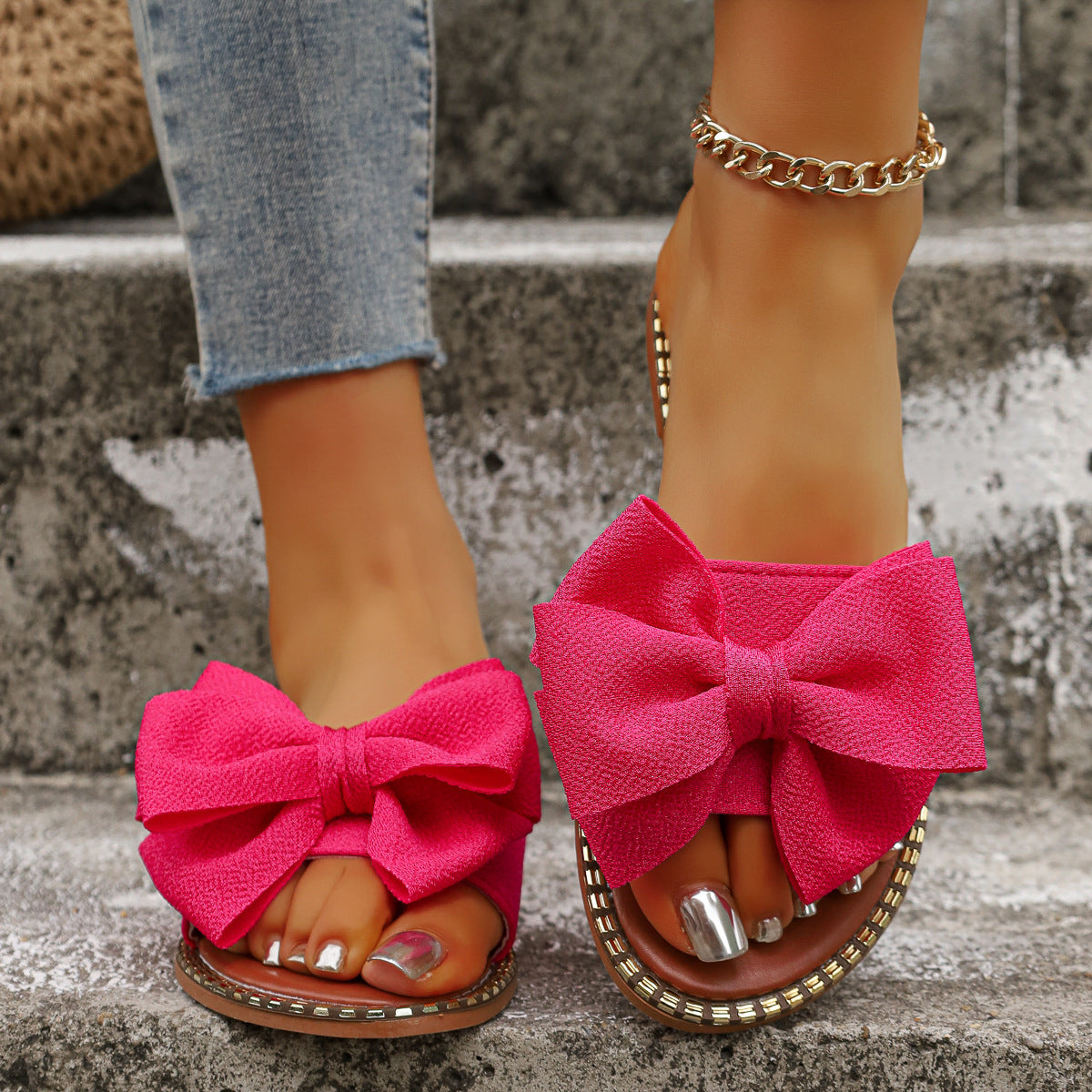 Plush Fashion Hub bowknot embellished flat sandals with sleek straps and decorative bow detail on a neutral background