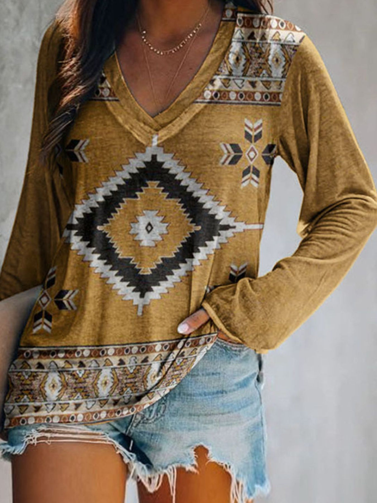 Plus size V-neck long sleeve T-shirt with geometric print from Plush Fashion Hub, casual top featuring a stylish design.