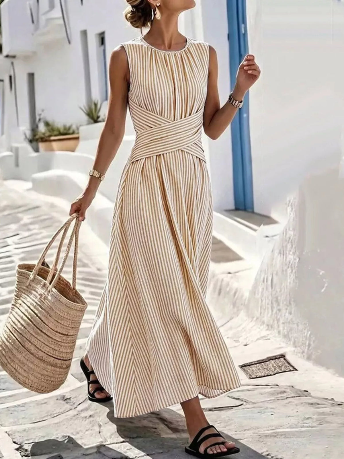 Plus size striped sleeveless maxi dress by Trendsi, featuring a full-length design with vibrant horizontal stripes and a flowing silhouette.