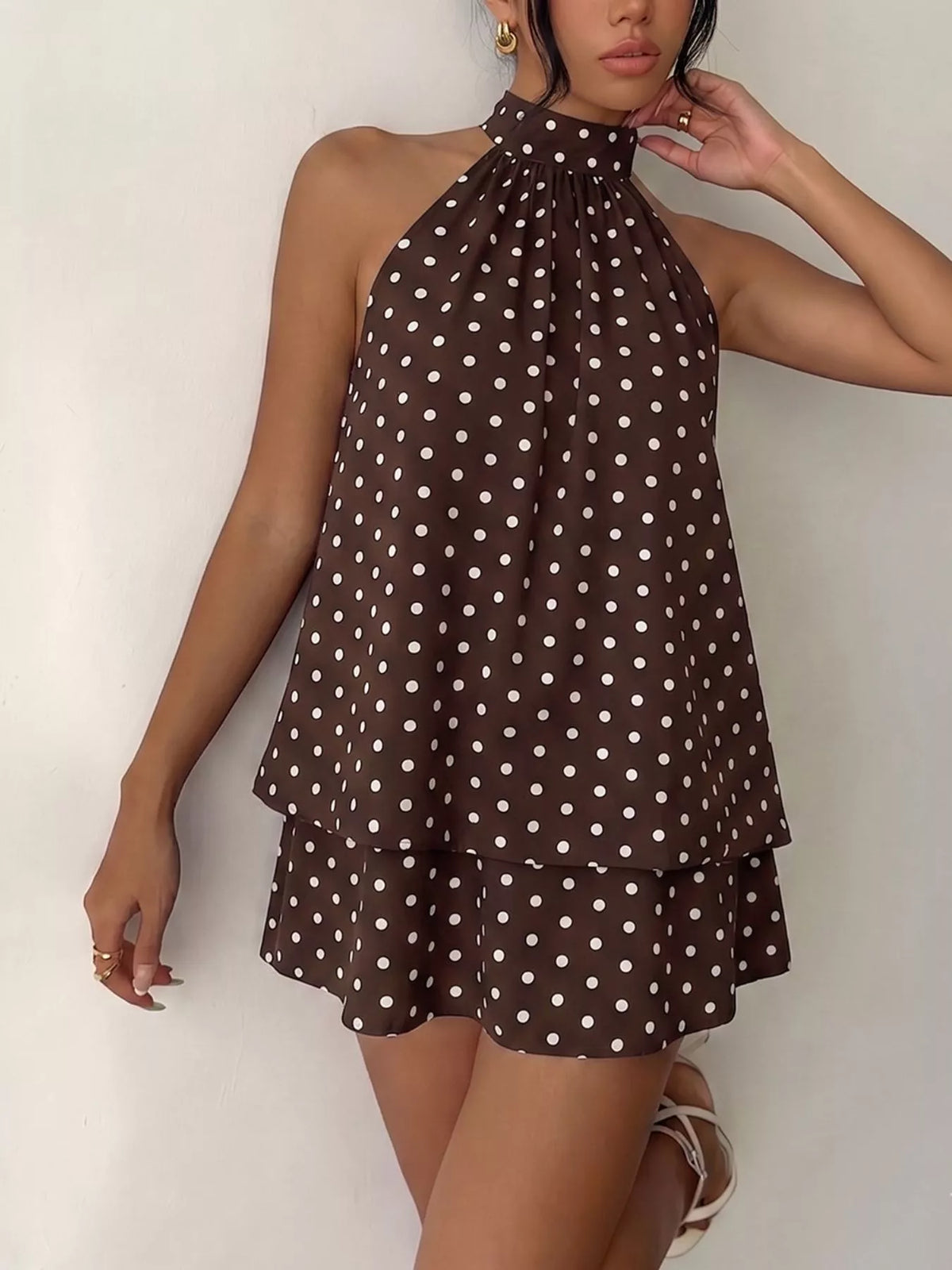 Polka dot halter neck mini dress by Plush Fashion Hub featuring a fitted bodice and playful polka dot pattern.