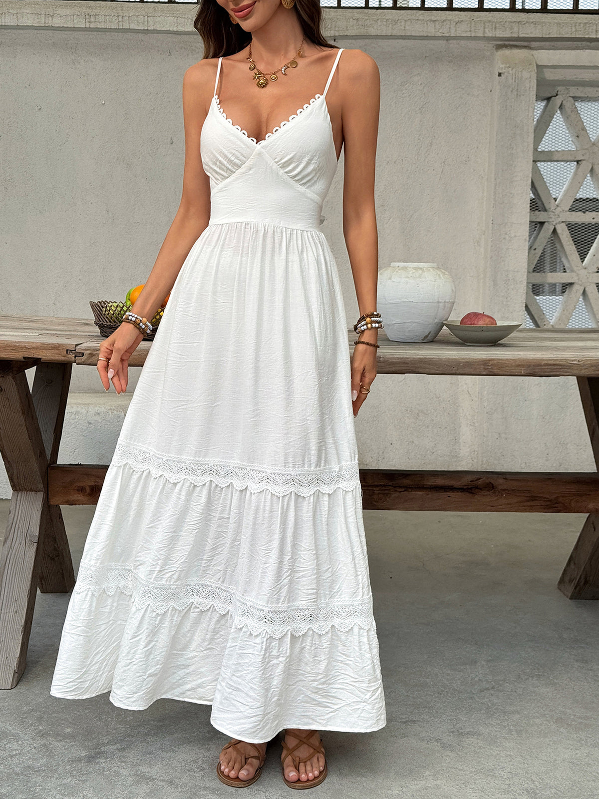 Women’s V-neck tiered maxi dress by Plush Fashion Hub with delicate lace details and flowing fabric.