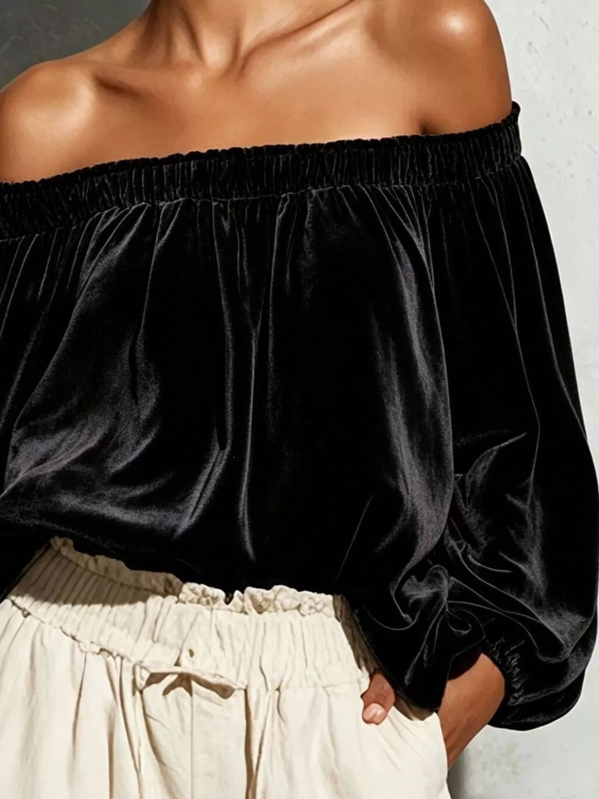 Off-shoulder velvet long sleeve T-shirt from Trendsi with a fitted style and soft fabric, shown in a neutral color.
