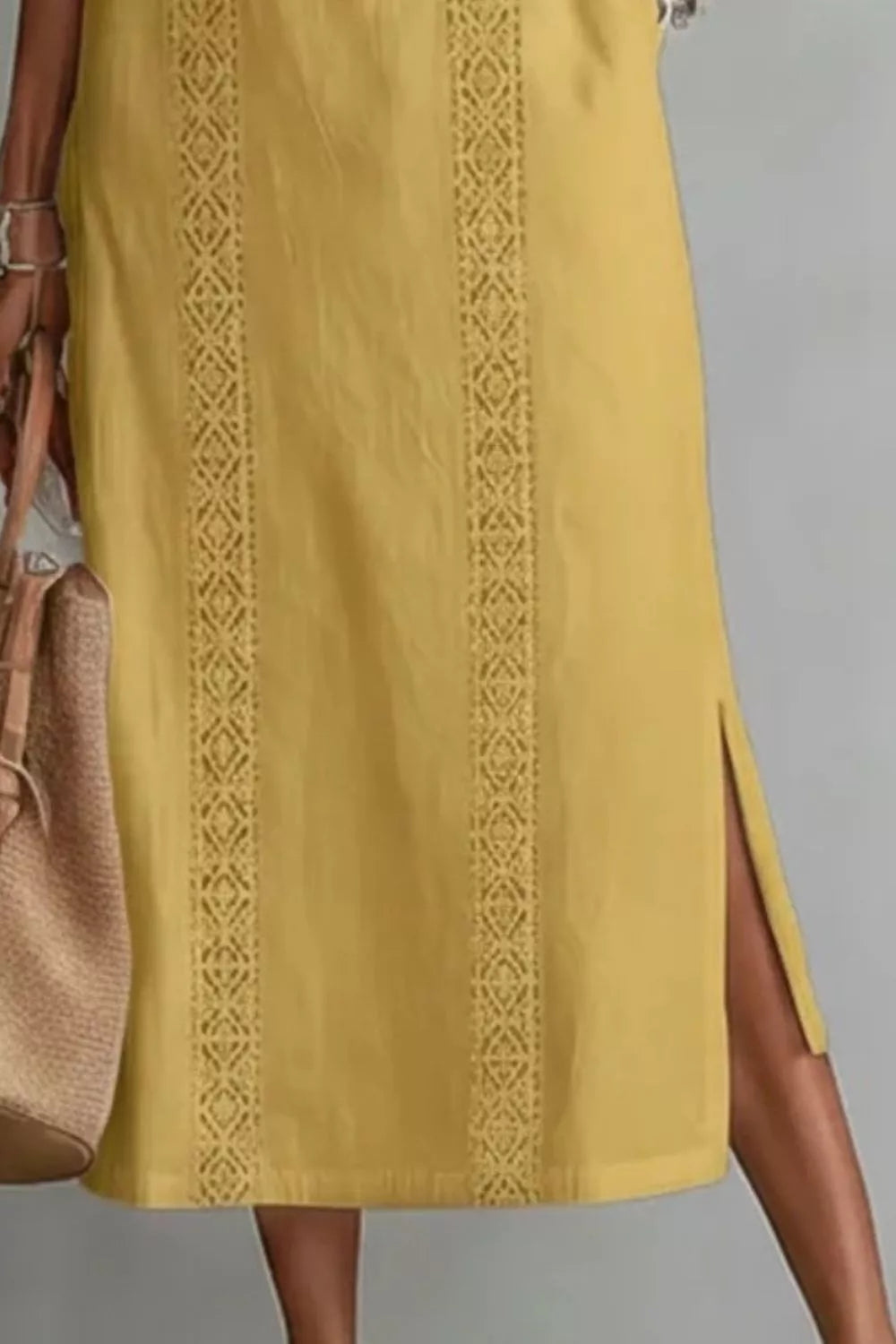 Women's sleeveless maxi dress with side slit and pockets by Trendsi, featuring a flowing silhouette and stylish design.