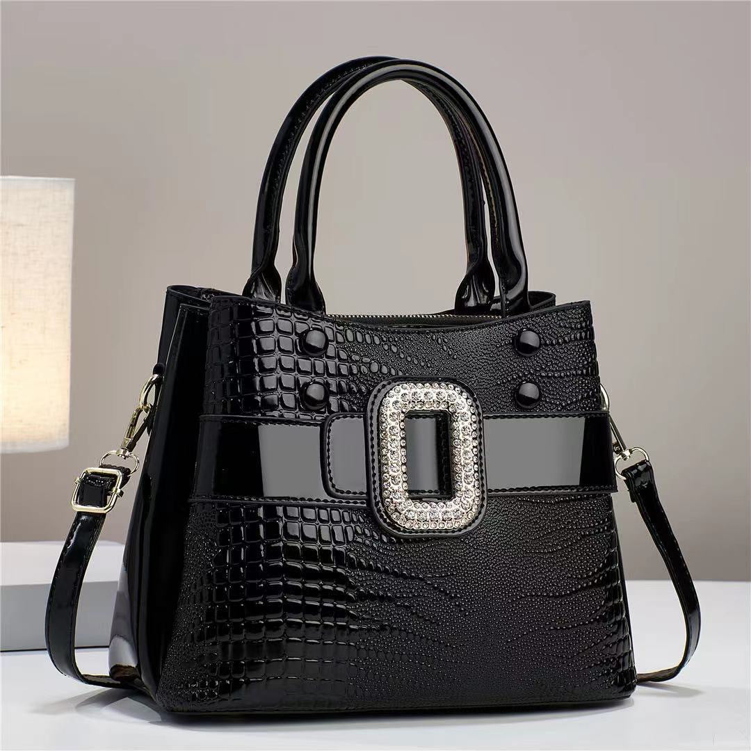 Lizard patterned mini bucket crossbody bag with zipper in beige and brown from Plush Fashion Hub, showing the textured design and adjustable strap.