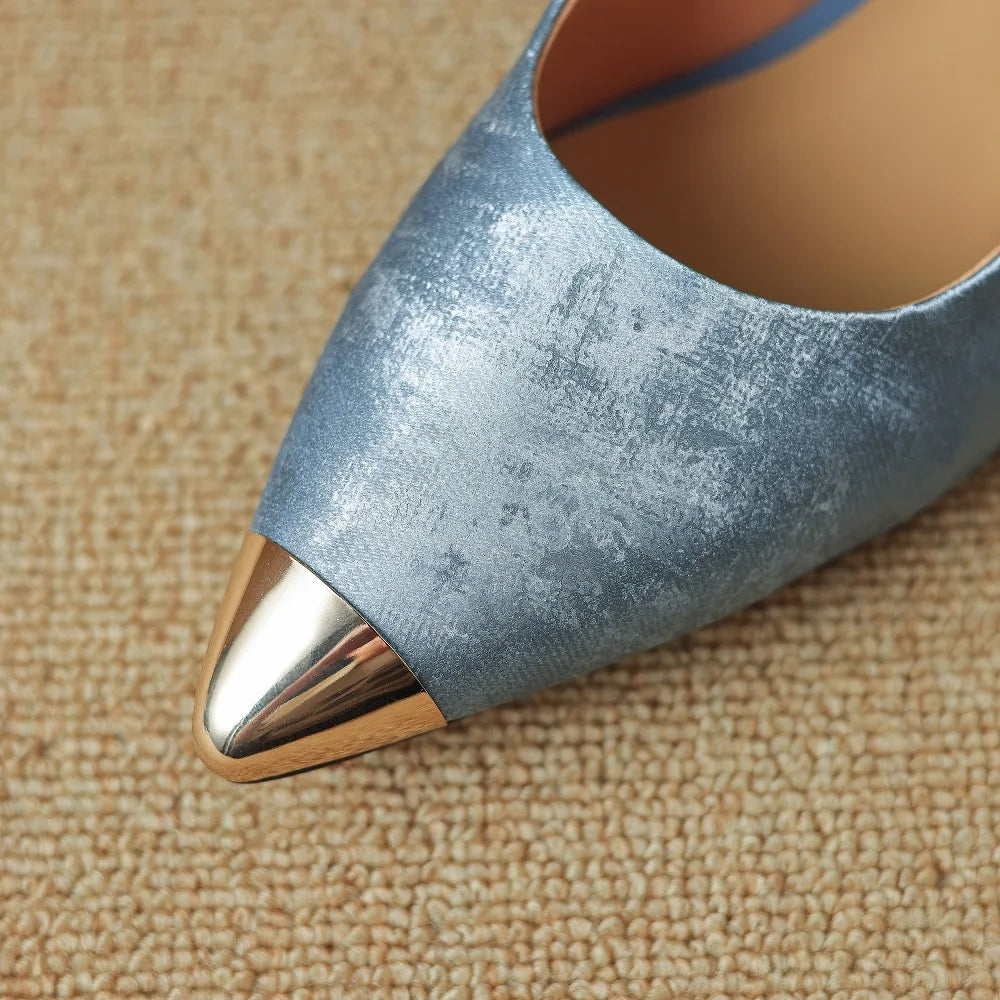 Pointed-toe stiletto heel in metallic blue distressed leather with a shiny gold-tone metal cap toe.