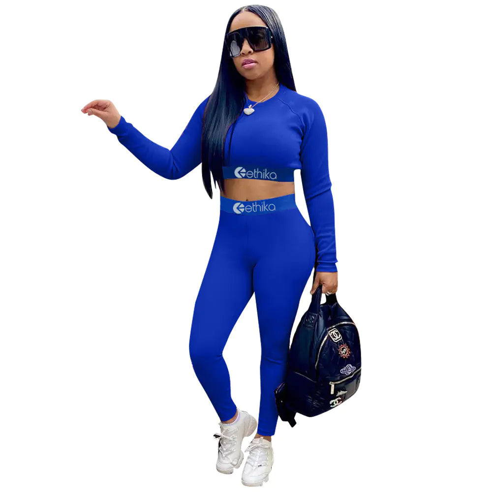 Women’s two-piece sports set with letter print, made by Plush Fashion Hub, featuring a comfortable athletic top and matching leggings.