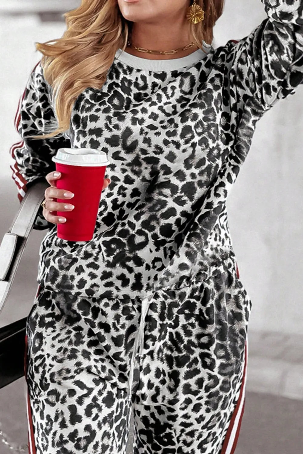 Plus size leopard print round neck top and matching pants set by Trendsi, featuring a stylish, comfortable, coordinated outfit.