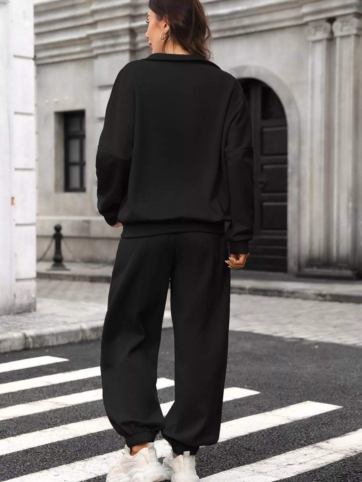 Women's zip-up long sleeve top and pants set by Trendsi, featuring a comfortable matching activewear or loungewear outfit.