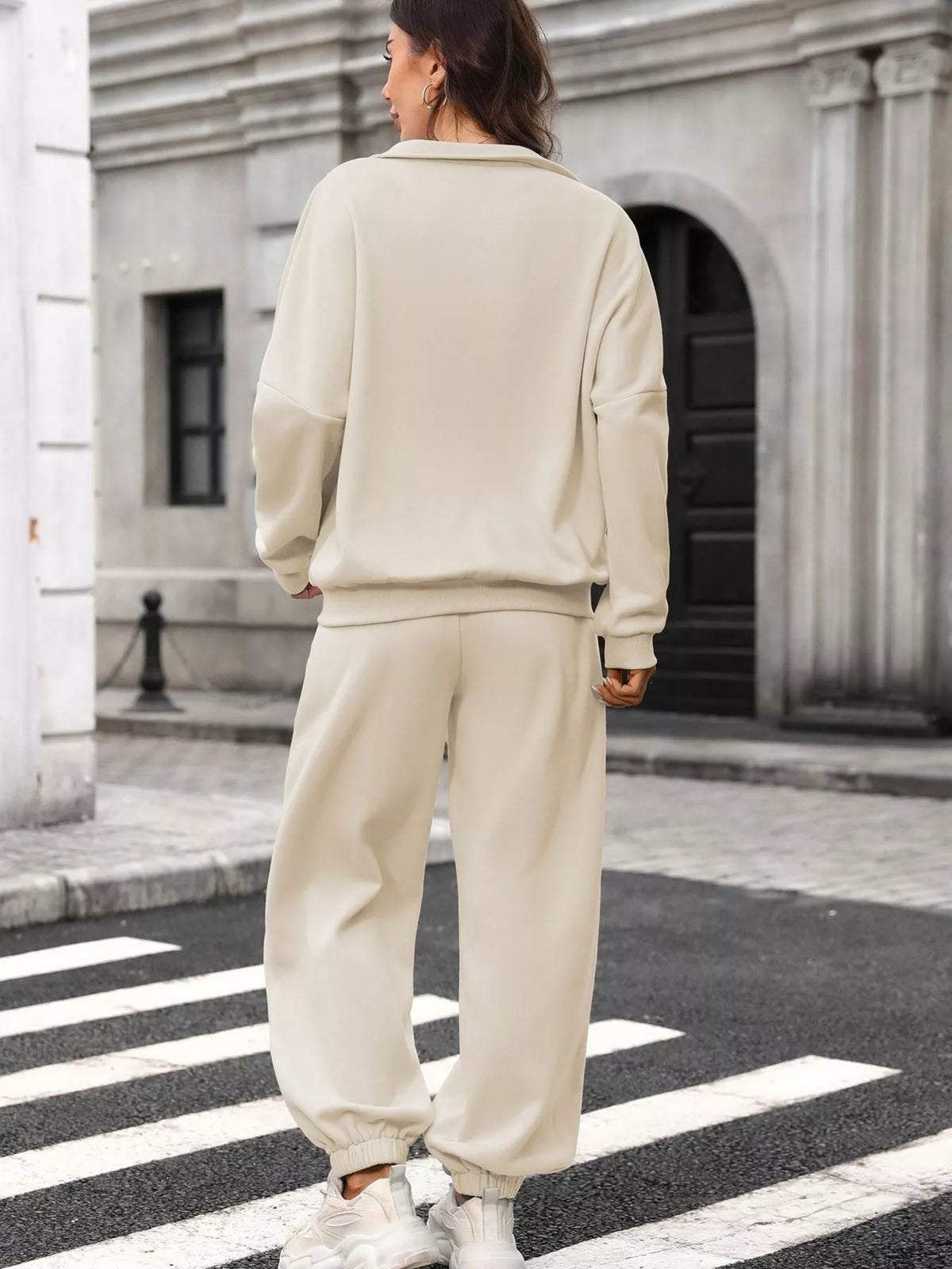 Women's zip-up long sleeve top and pants set by Trendsi, shown in a coordinated matching style on a model.