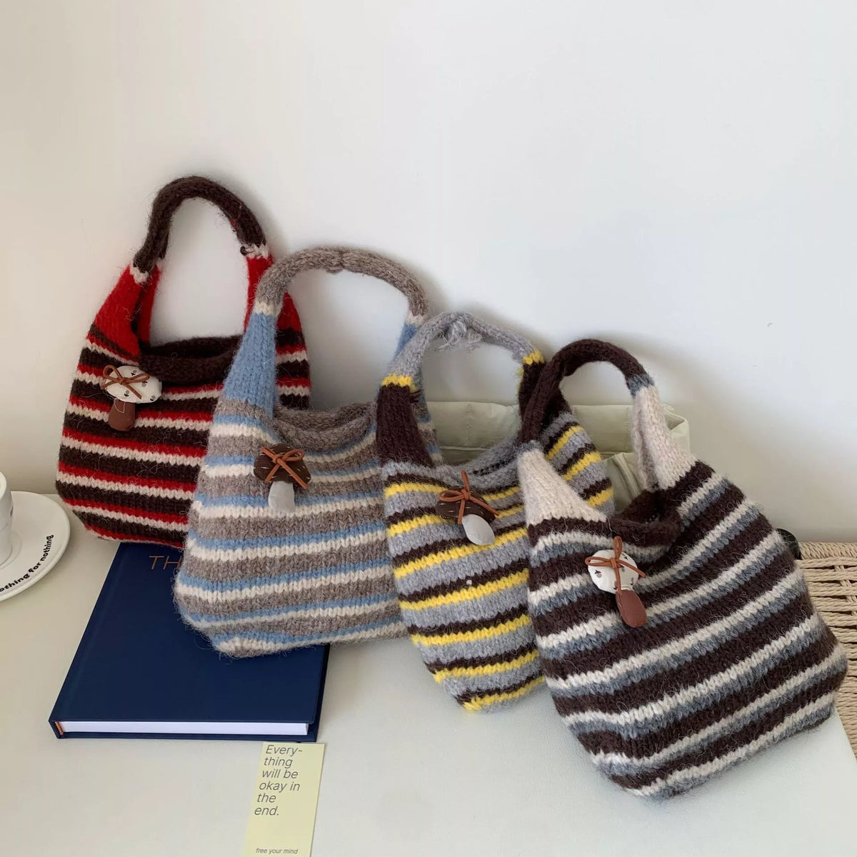 Colorful knitted striped handbag by Plush Fashion Hub, featuring a cozy woven design and sturdy handle for casual style.
