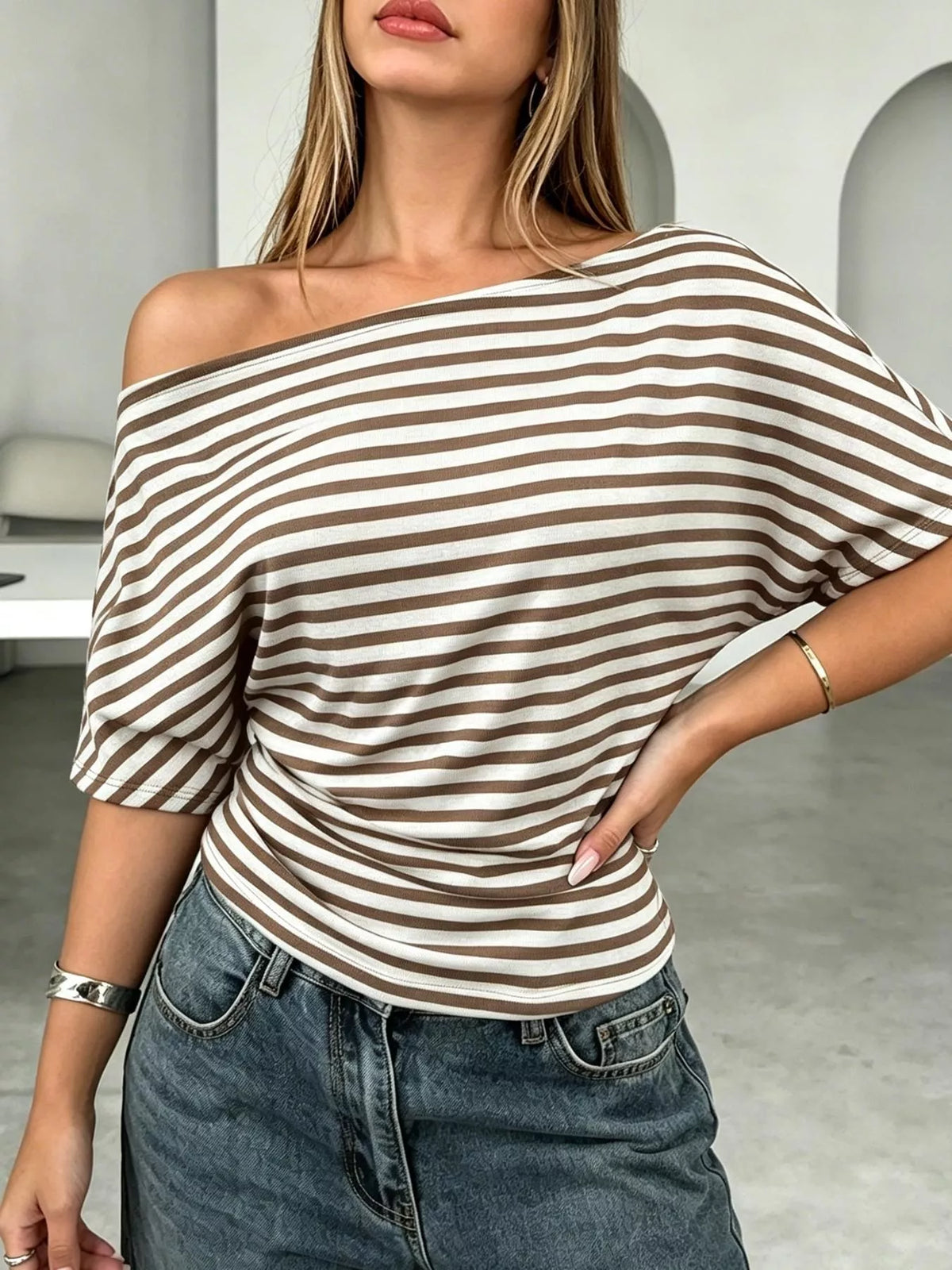 Striped one-shoulder dolman sleeve T-shirt by Plush Fashion Hub featuring casual style and relaxed fit.