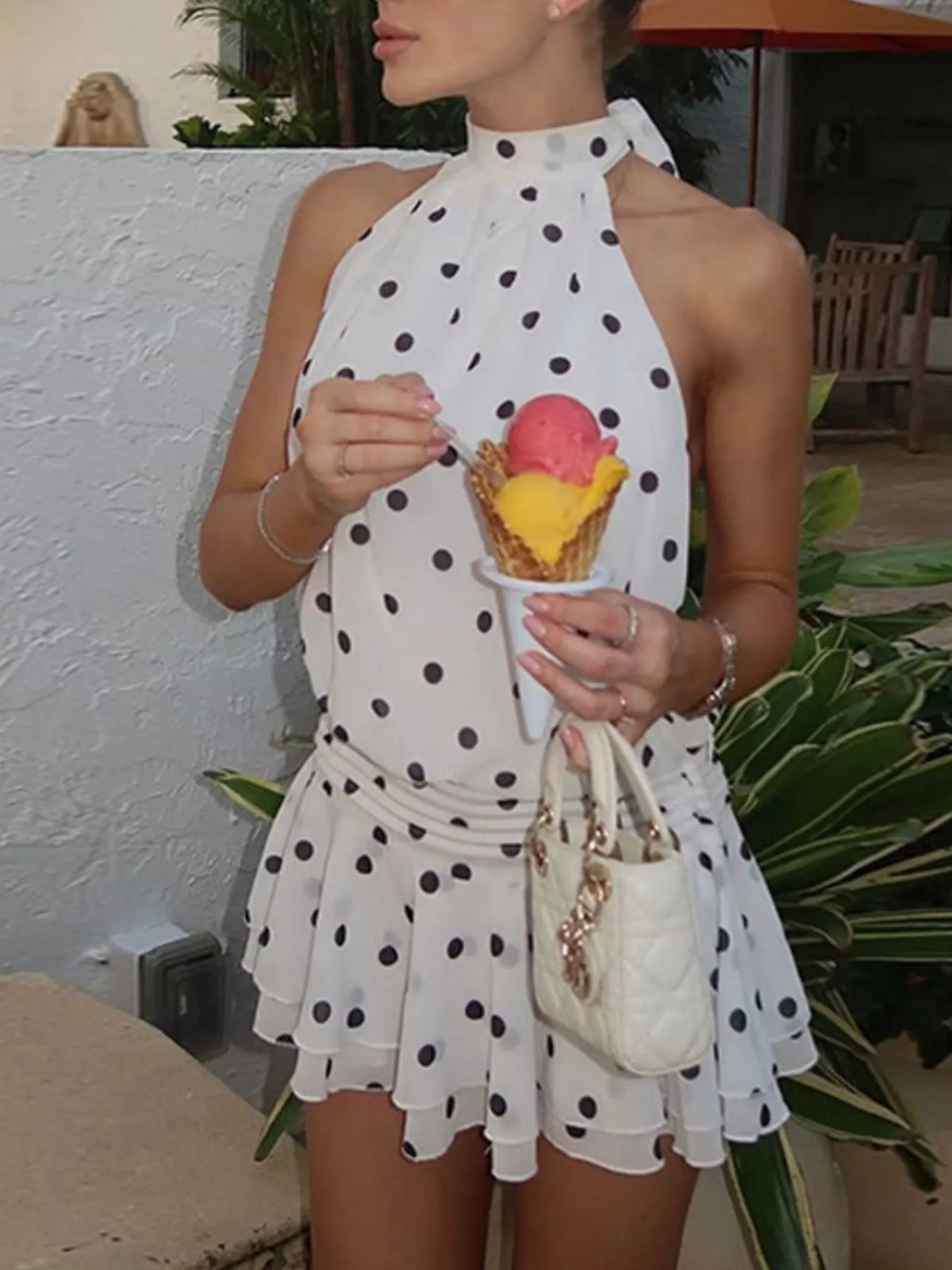 Polka dot halter neck ruffle dress by Plush Fashion Hub featuring a stylish design and playful pattern.