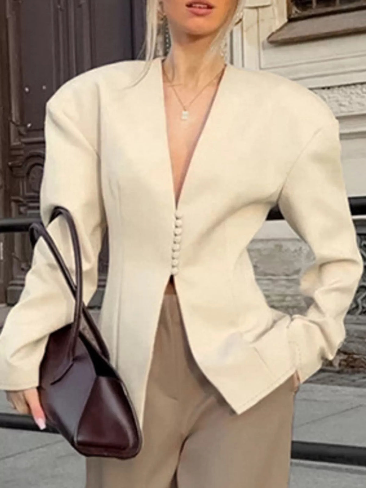 Trendsi women's V-neck button-up blazer with structured shoulders, tailored fit, and classic design in neutral fabric.