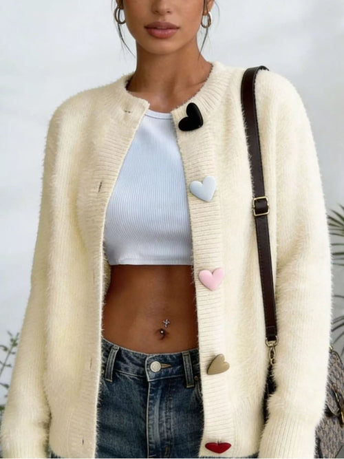 Plus size full-length heart button long sleeve cardigan knitwear by Trendsi, featuring a cozy design with a front button closure.
