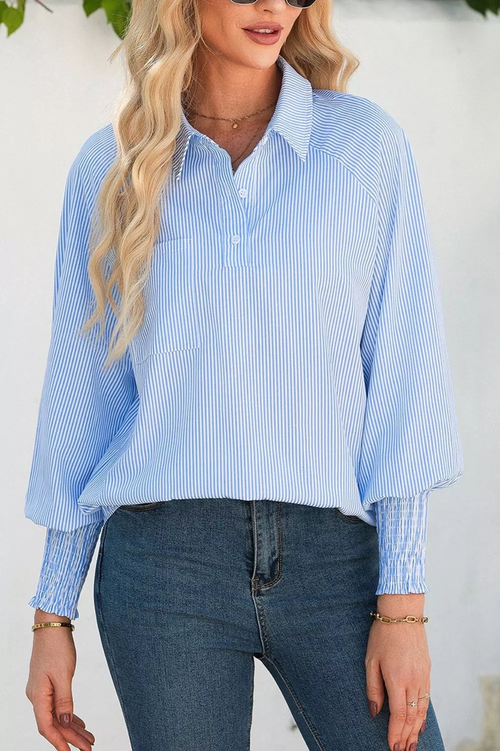 Striped smocked sleeve collared blouse from Trendsi featuring a relaxed fit and button-up front, displayed on a hanger.