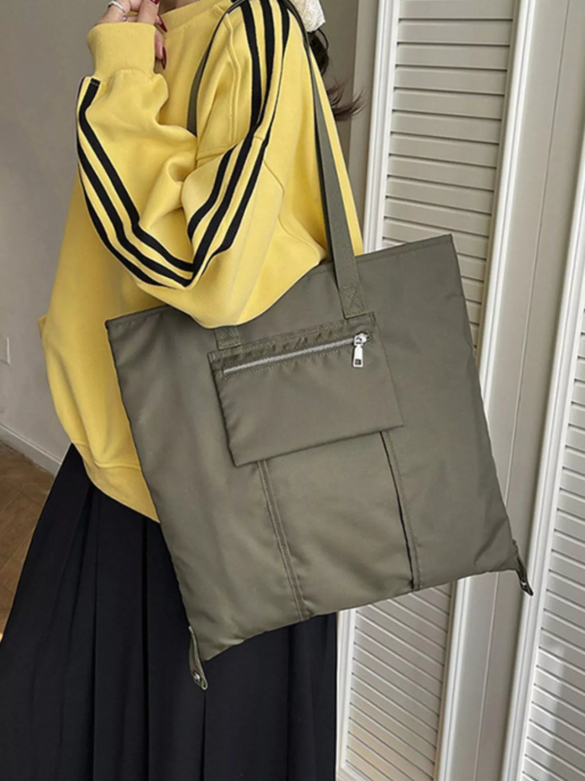 Lightweight nylon shoulder bag from Plush Fashion Hub, casual design with adjustable strap and spacious interior.