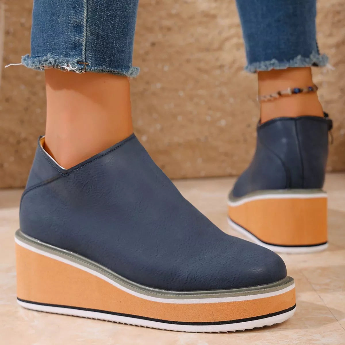 Women's round toe wedge ankle boots by Trendsi featuring a stylish design and ankle-high silhouette.