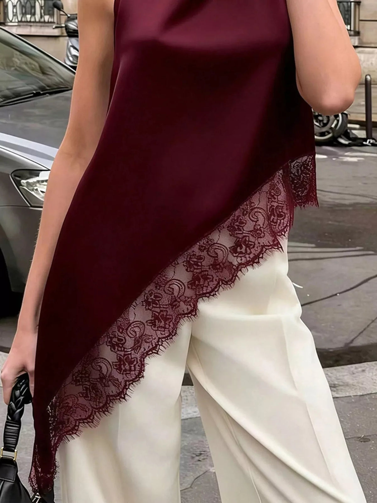 Plush Fashion Hub sleeveless blouse with polka dot lace trim, asymmetrical hem, stylish shirt for casual or dressy wear.