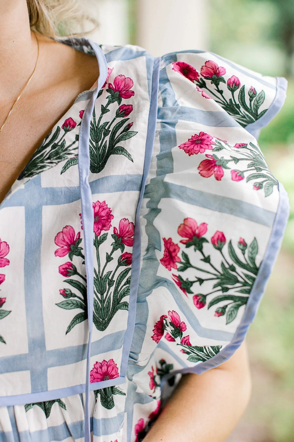 Women’s floral print ruffle sleeve blouse by Plush Fashion Hub featuring a tied neckline and lightweight fabric.
