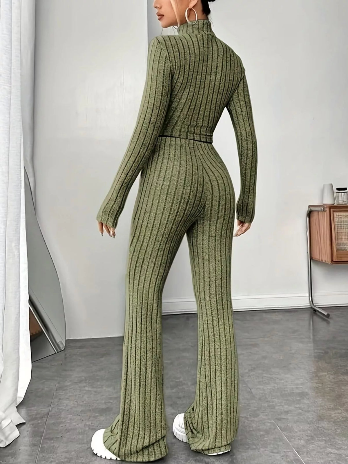 Ribbed turtleneck crop top and flare pants sweater set from Trendsi, featuring a fitted ribbed texture and stylish silhouette.