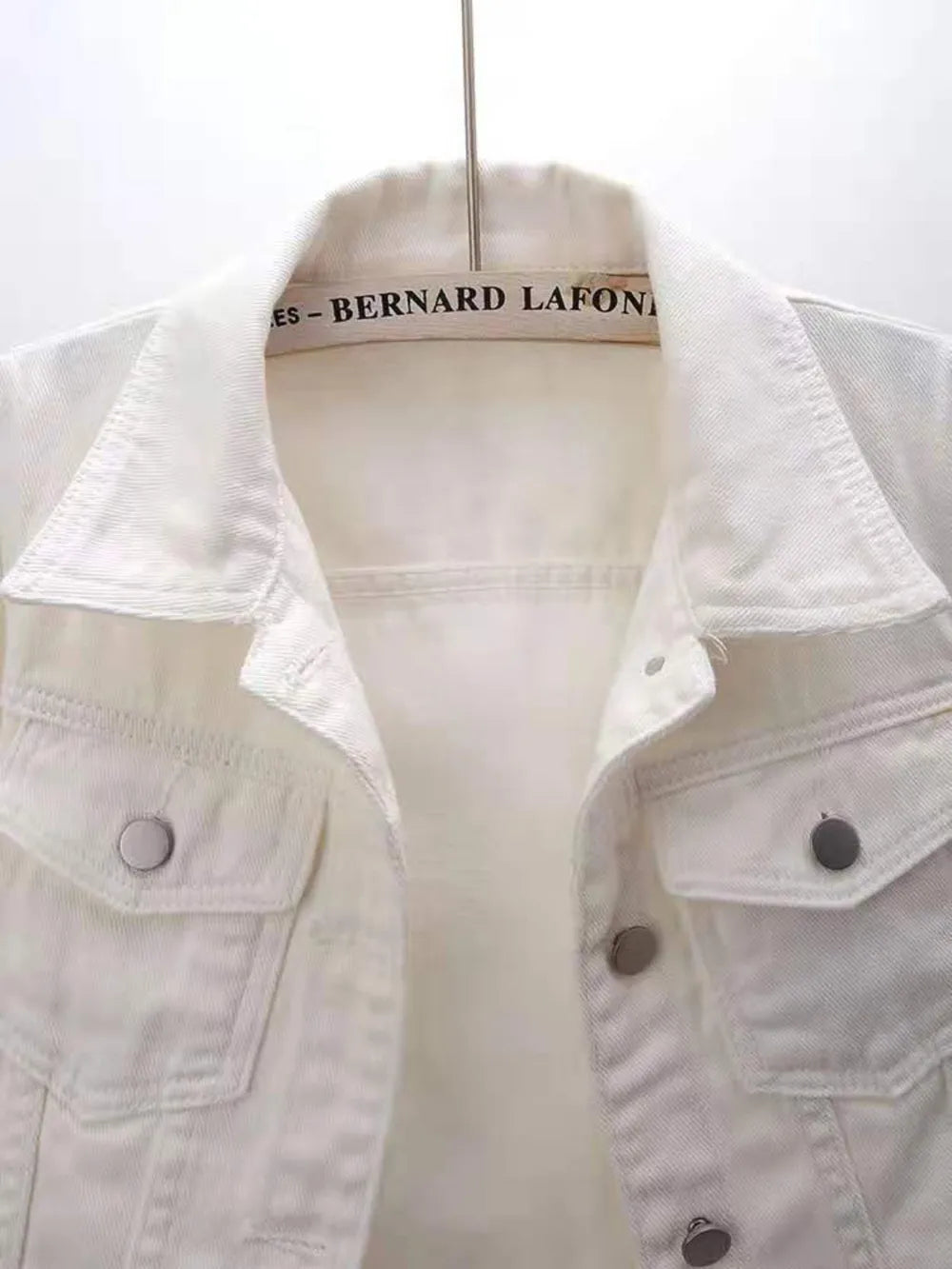 Plus size full length cropped denim jacket from Trendsi, showcasing classic blue denim with front pockets and button closure.