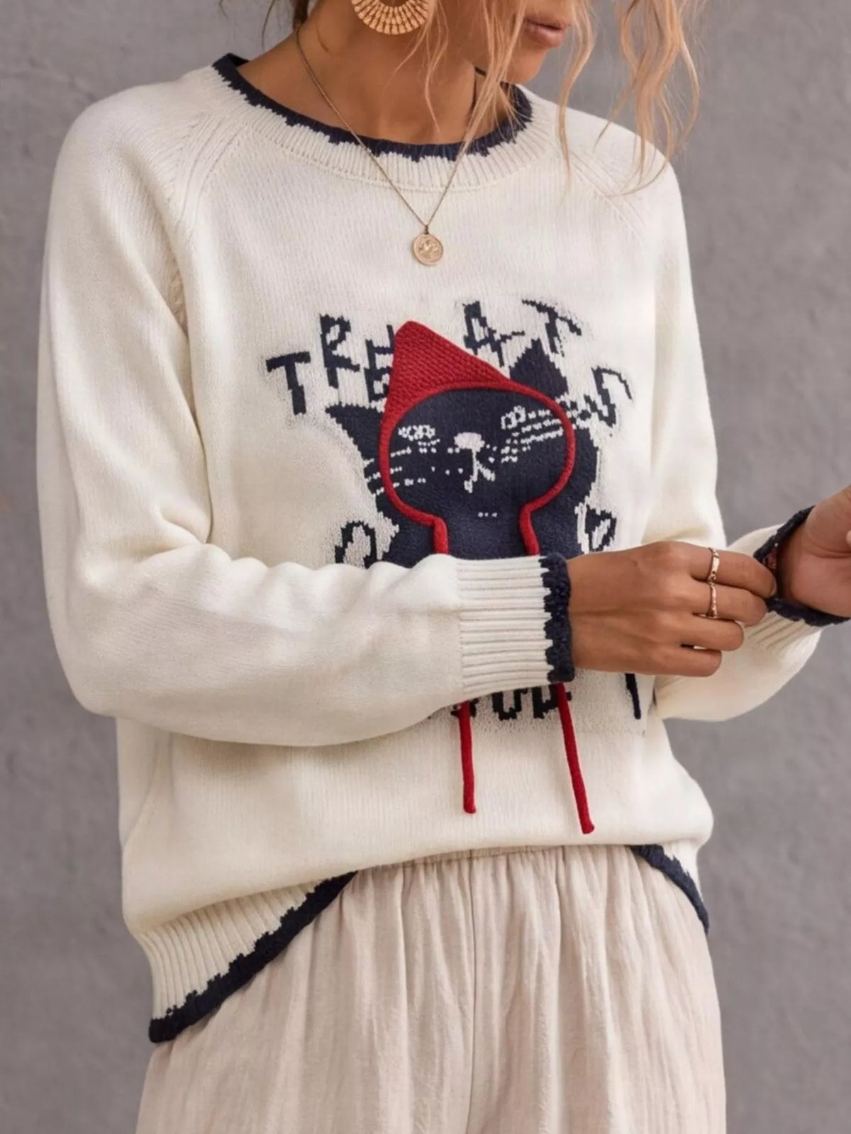 Cat raglan sleeve sweater by Trendsi featuring a cozy knit design with playful cat patterns on a soft fabric background.