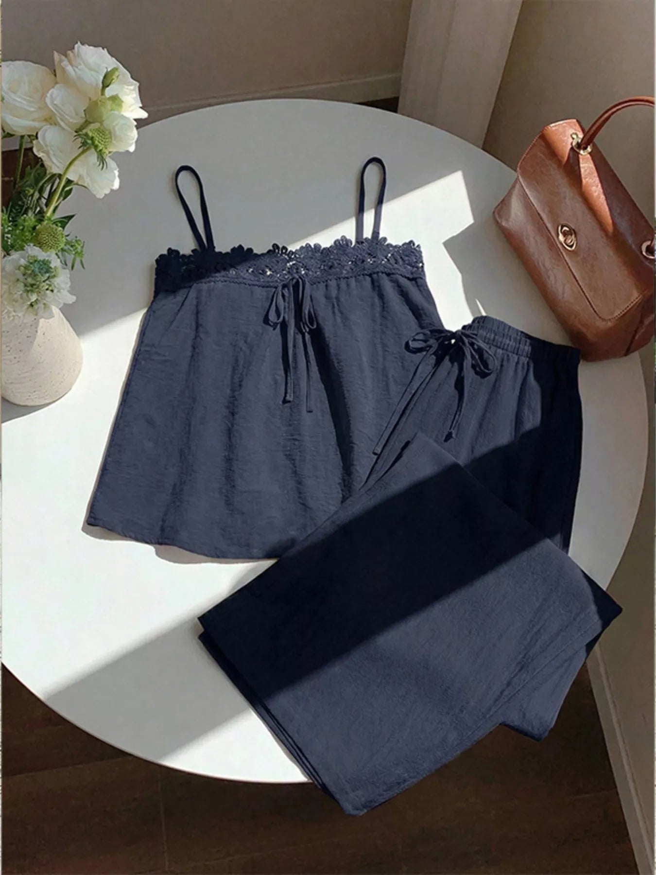 Lace trim cami and wide-leg pants matching set by Trendsi, featuring a stylish camisole with lace details and flowy pants.